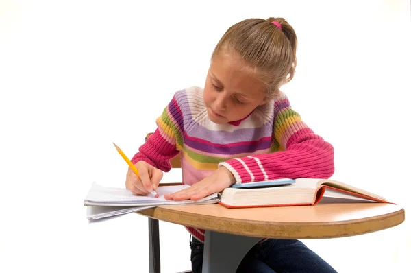 Jong meisje aan balie in school op wit — Stockfoto