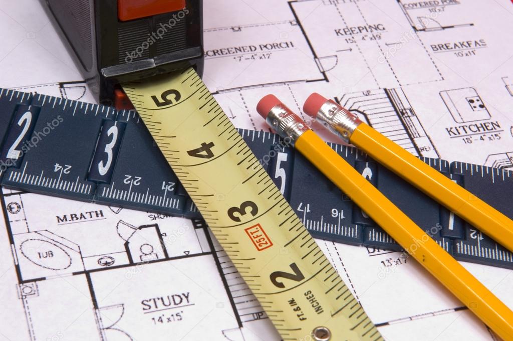 Measuring Tape and Ruler with pencils on house floorplan