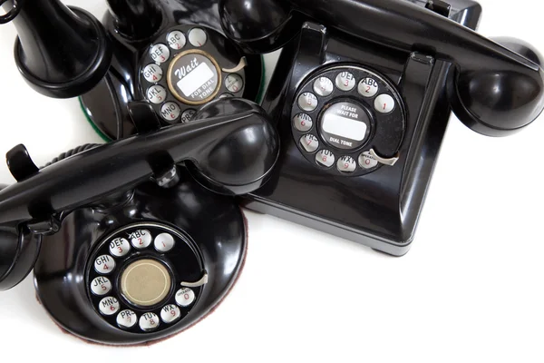 A group of vintage telephones on a white background — Stock Photo, Image