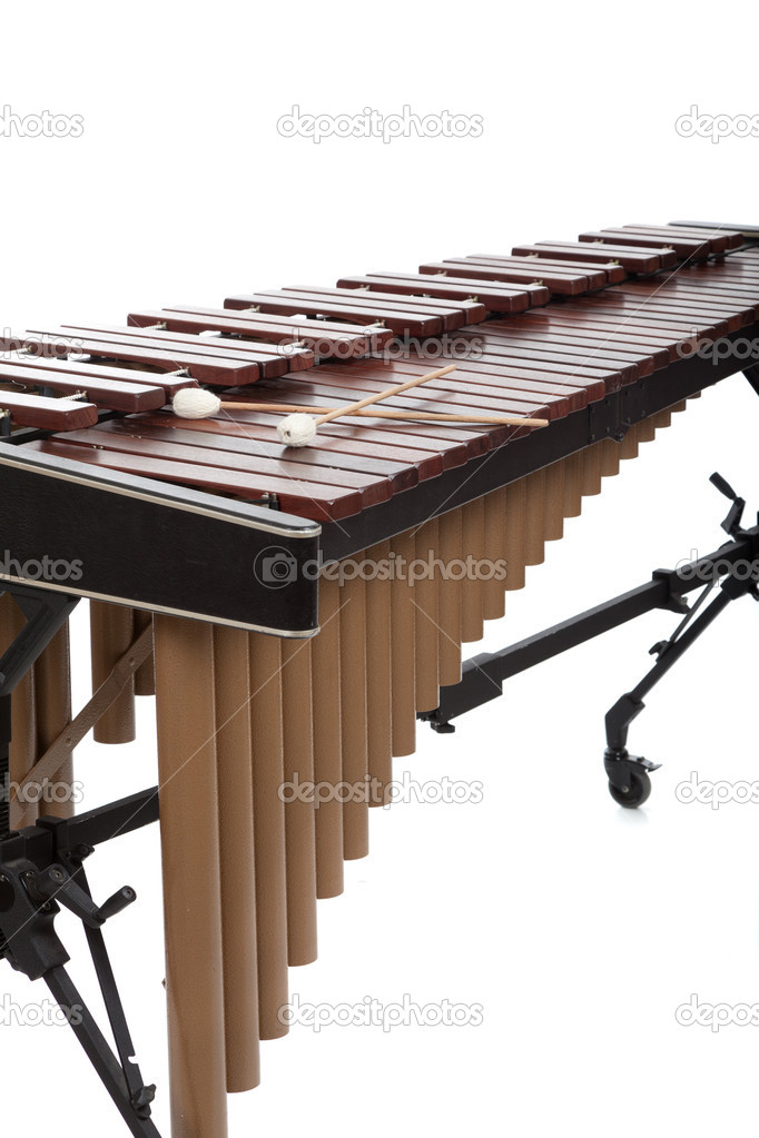 A brown wooden marimba on a white background