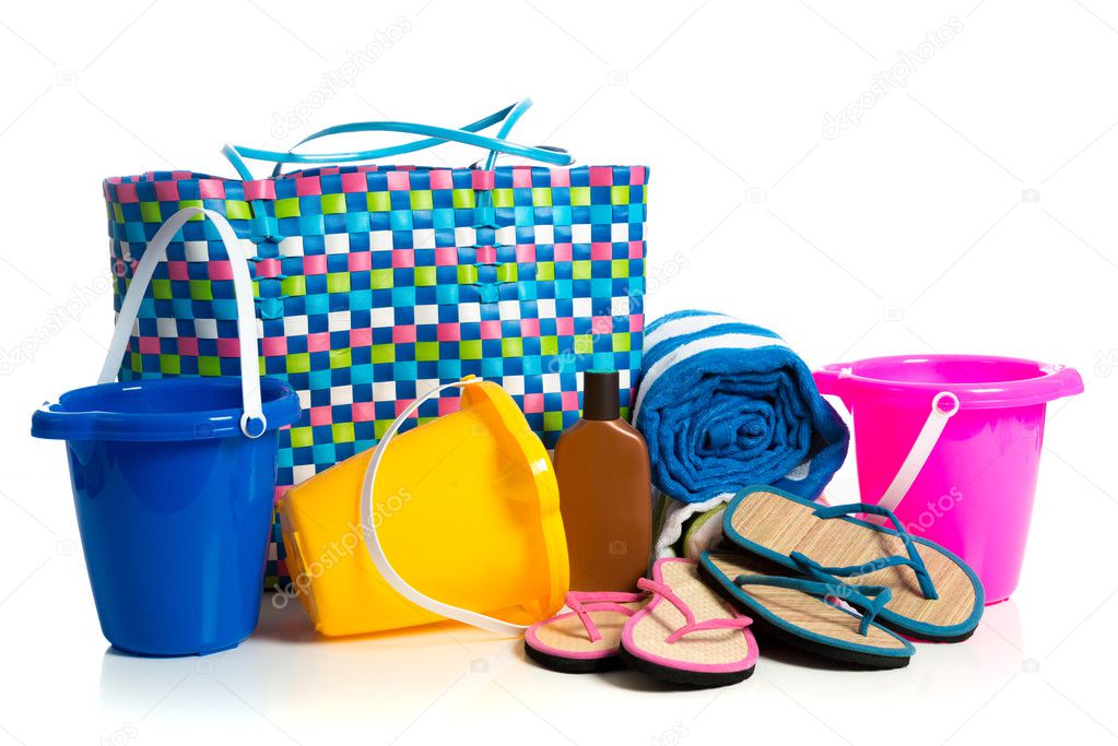 Beach bag with buckets, towel, flip-flops and suntan lotion