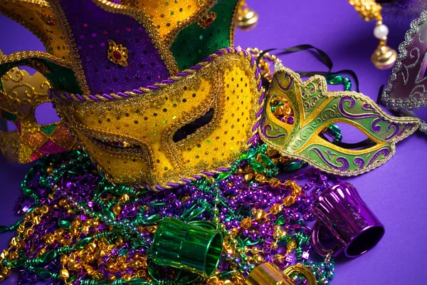 Assorted Mardi Gras or Carnivale mask on a purple background — Stock Photo, Image