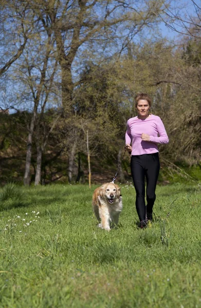 Девушка, бегающая с собакой — стоковое фото