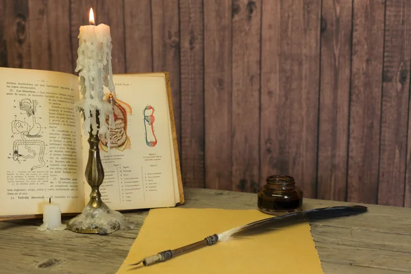 Table with old book — Stock Photo, Image