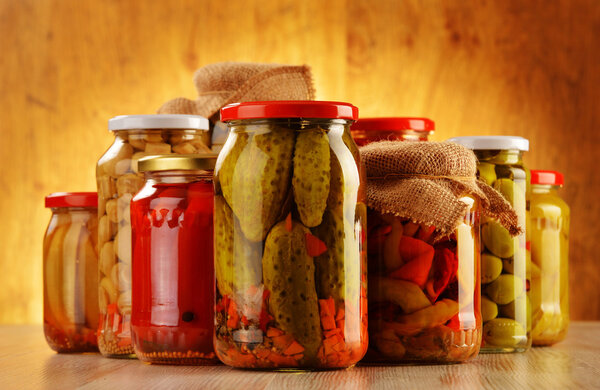 Composition with jars of pickled vegetables. Marinated food