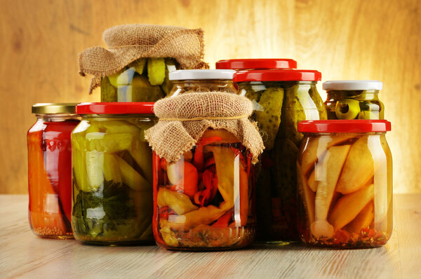 Composition with jars of pickled vegetables. Marinated food
