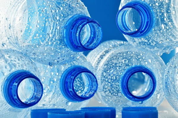 Composition with empty polycarbonate plastic bottles of mineral — Stock Photo, Image