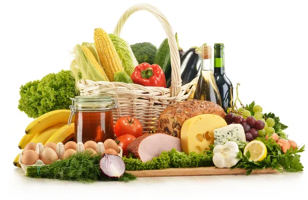 Composition avec épicerie dans un panier en osier sur une table de cuisine — Photo