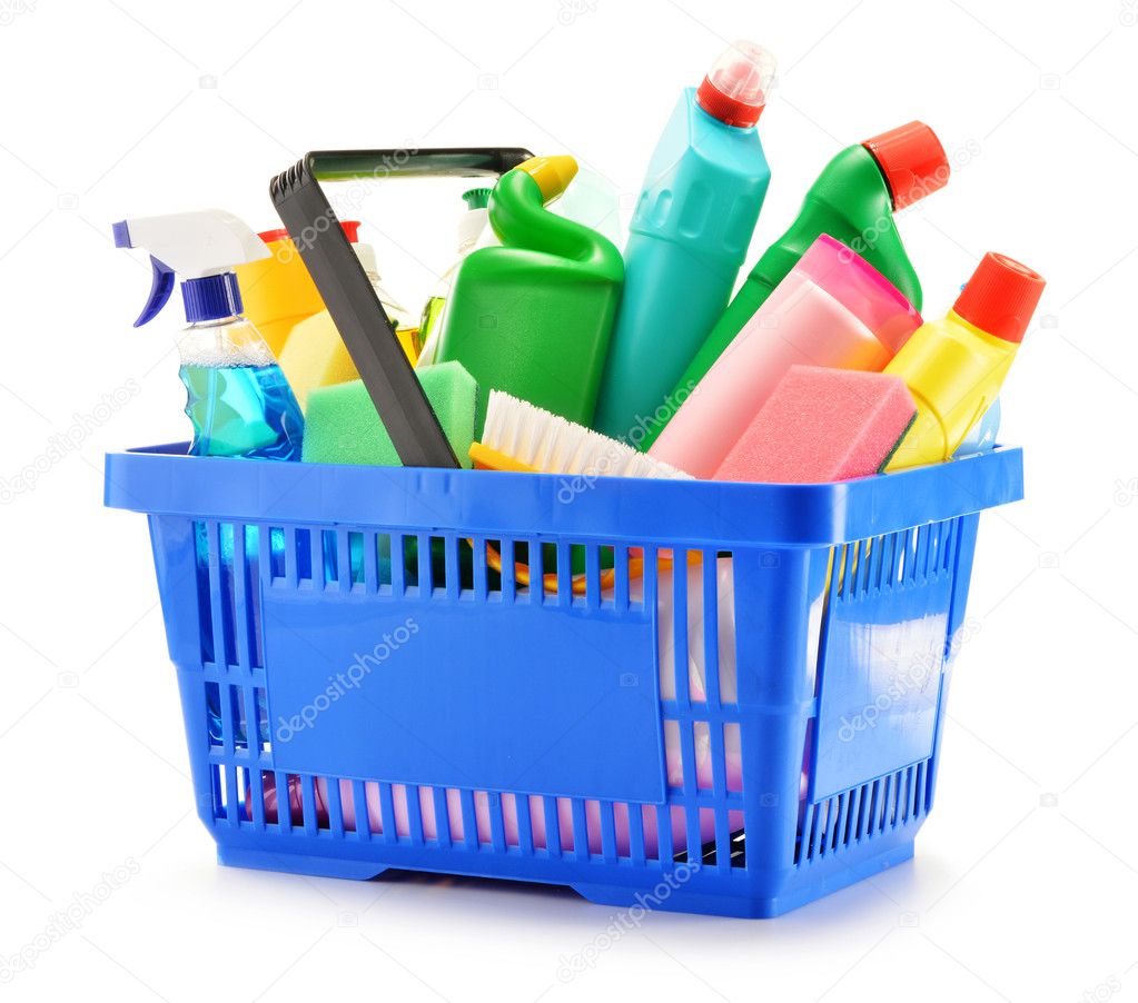 Shopping basket with detergent bottles isolated on white