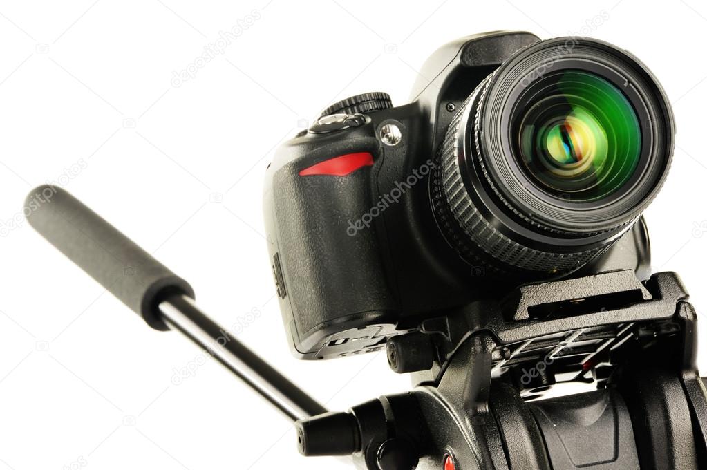 Single-lens reflex camera on tripod isolated on white