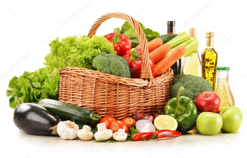 raw vegetables in wicker basket isolated on white