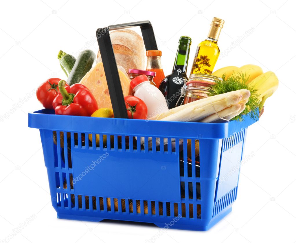 Plastic shopping basket with variety of grocery products Stock Photo by