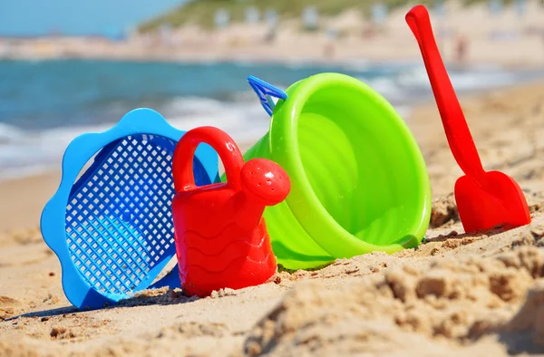 Plastic children toys on the sand beach — Stock Photo, Image