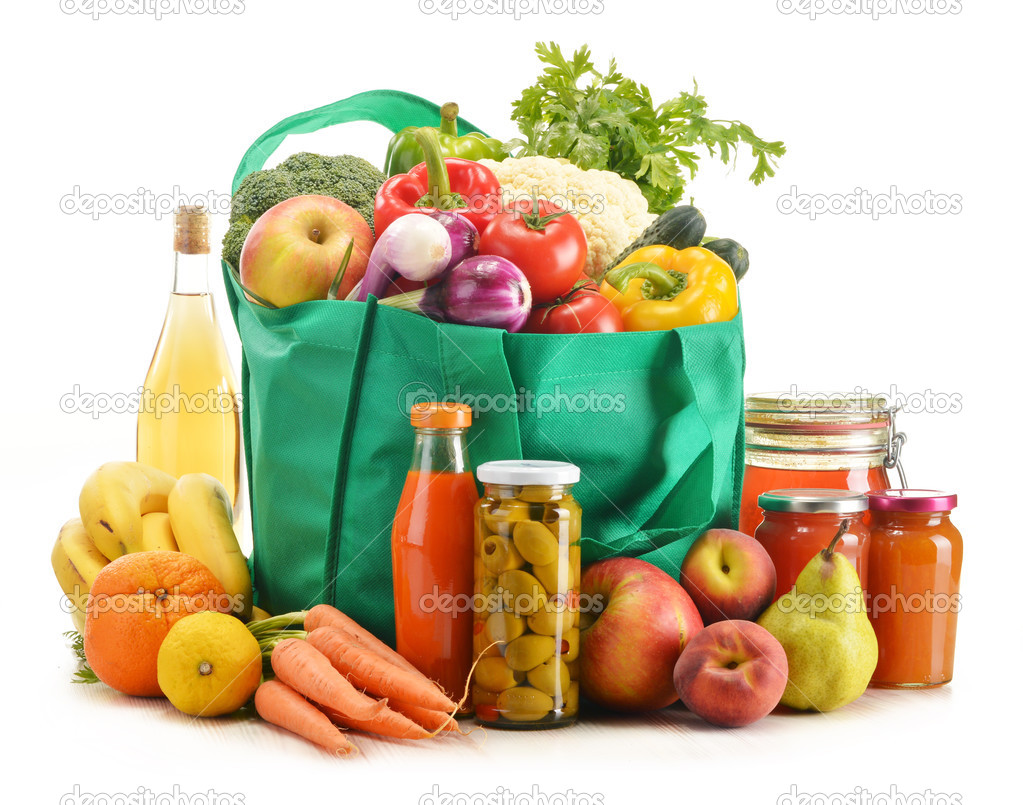 Green shopping bag with grocery products on white background