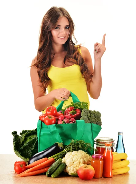 Young woman with variety of grocery products in shopping bag — Stock Photo, Image