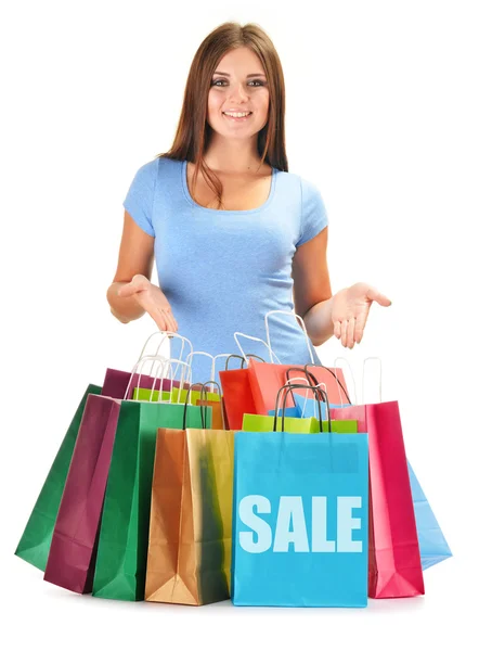 Mujer feliz joven con bolsas de compras de papel de colores aislados — Foto de Stock