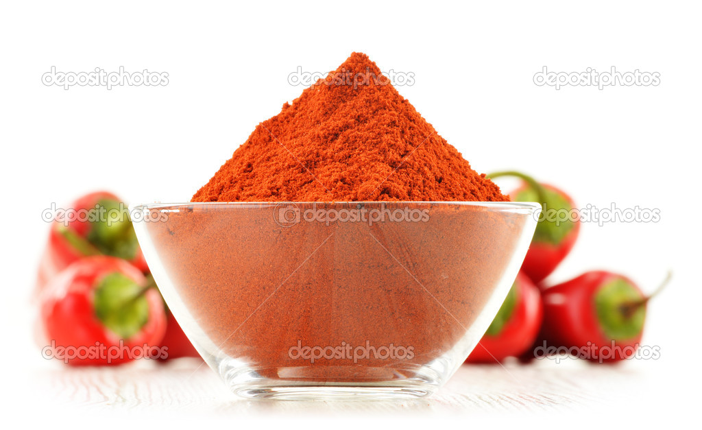 Glass bowl with red hot chili pepper isolated on white