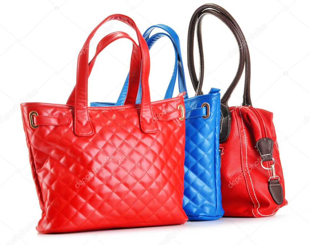 Three leather handbags isolated on white