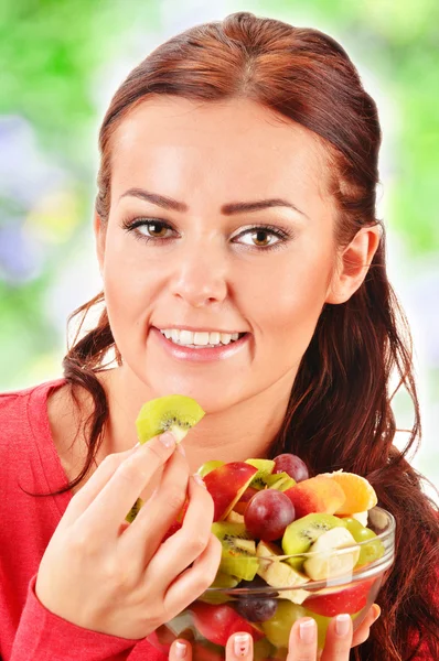 Молода жінка їсть фруктовий салат — стокове фото