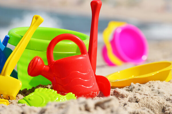 Plastic children toys on the sand beach