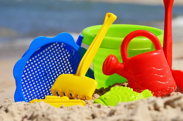 Plastic children toys on the sand beach — Stock Photo, Image