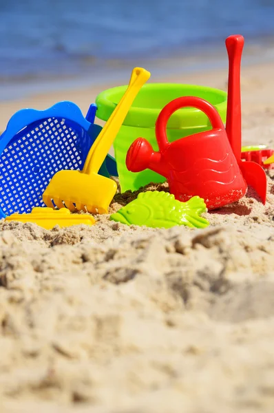 Plastic children toys on the sand beach — Stock Photo, Image