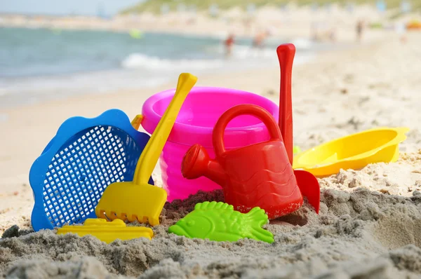 Plastic children toys on the sand beach — Stock Photo, Image