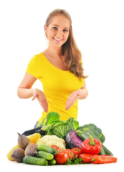 Mujer joven con una variedad de verduras aisladas en blanco —  Fotos de Stock