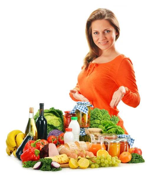 Young woman with variety of grocery products isolated on white — Stock Photo, Image