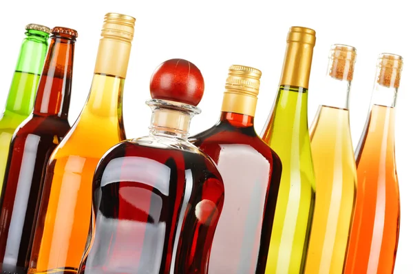 Bottles of assorted alcoholic beverages isolated on white — Stock Photo, Image