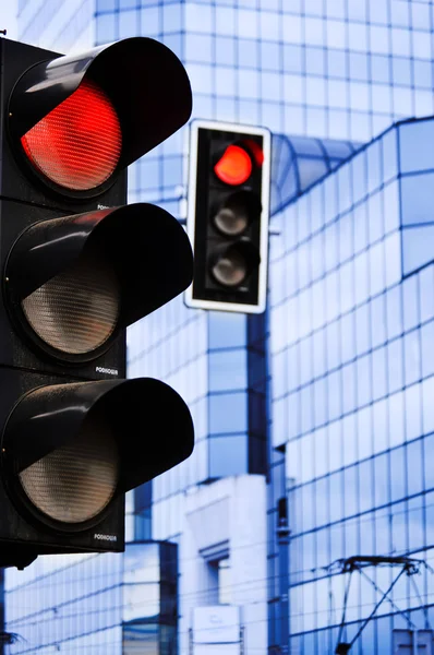 Traffic lights over modern business architecture