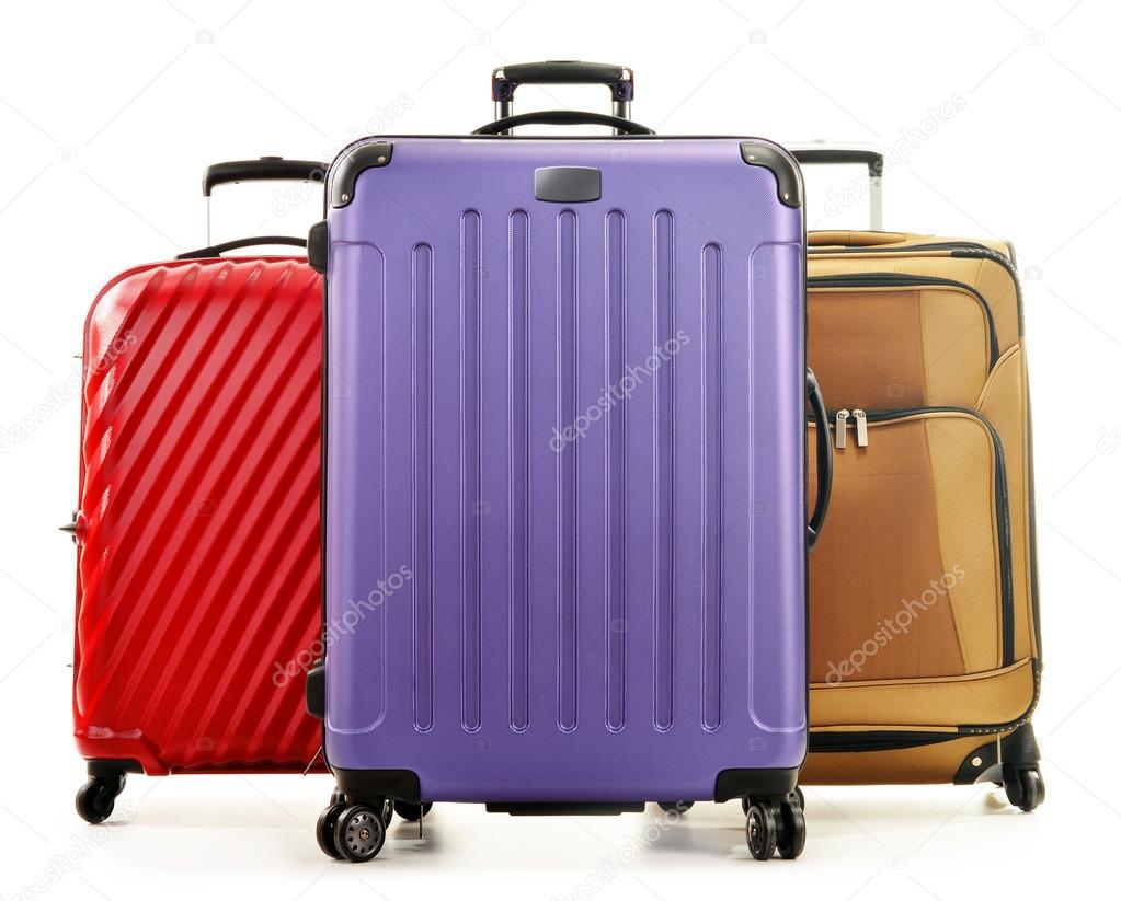 Three large suitcases isolated on white background