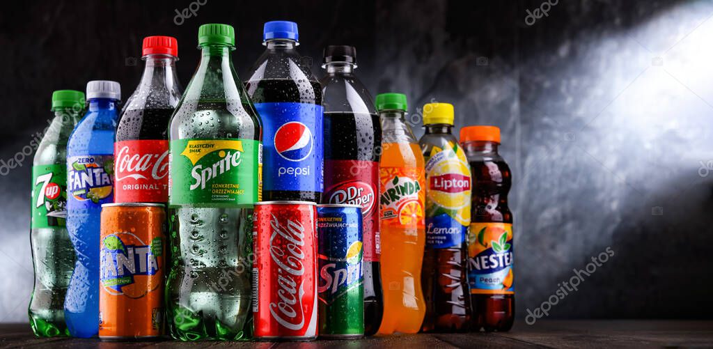 POZNAN, POLAND - OCT 28, 2021: Bottles of global soft drink brands including products of Coca Cola Company and Pepsico