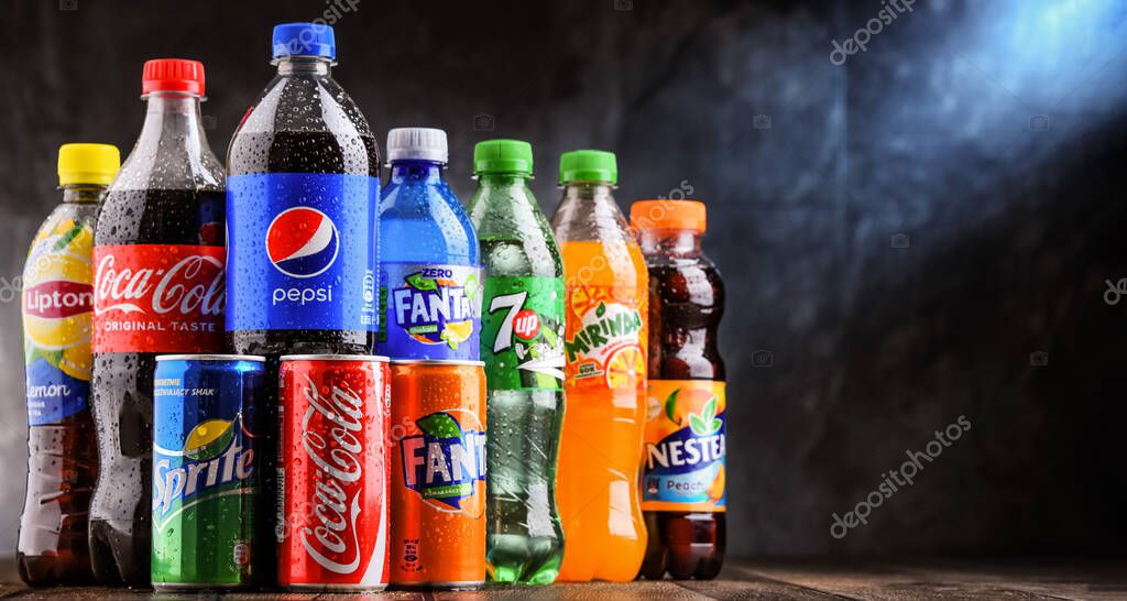 POZNAN, POLAND - OCT 28, 2021: Bottles of global soft drink brands including products of Coca Cola Company and Pepsico