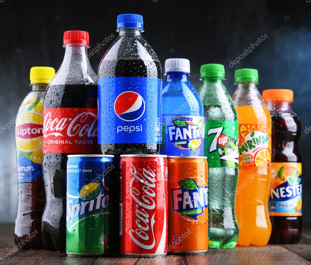 POZNAN, POLAND - OCT 28, 2021: Bottles of global soft drink brands including products of Coca Cola Company and Pepsico