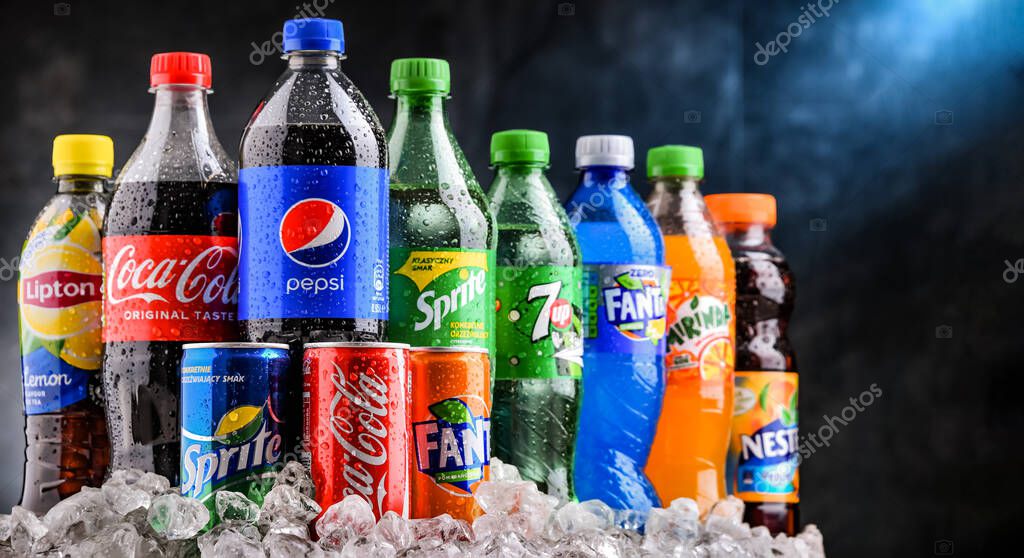POZNAN, POLAND - OCT 28, 2021: Bottles of global soft drink brands including products of Coca Cola Company and Pepsico