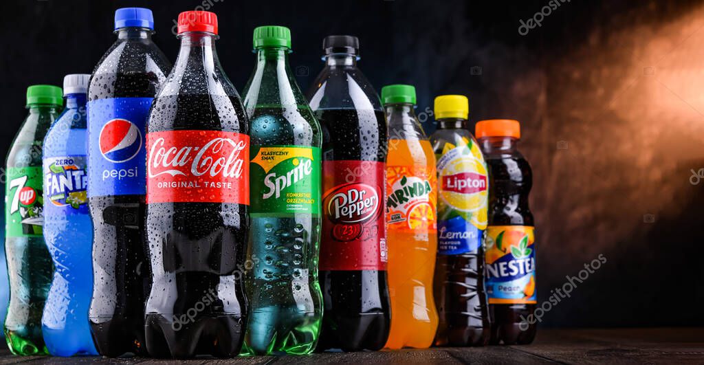 POZNAN, POLAND - OCT 28, 2021: Bottles of global soft drink brands including products of Coca Cola Company and Pepsico