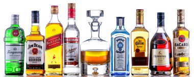 POZNAN, POL - NOV 4, 2021: Bottles of assorted global hard  liquor brands including whiskey, vodka, tequila and gin  clipart