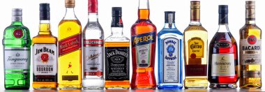 POZNAN, POL - NOV 4, 2021: Bottles of assorted global hard  liquor brands including whiskey, vodka, tequila and gin  clipart