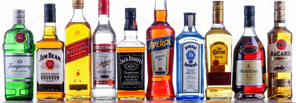 POZNAN, POL - NOV 4, 2021: Bottles of assorted global hard  liquor brands including whiskey, vodka, tequila and gin