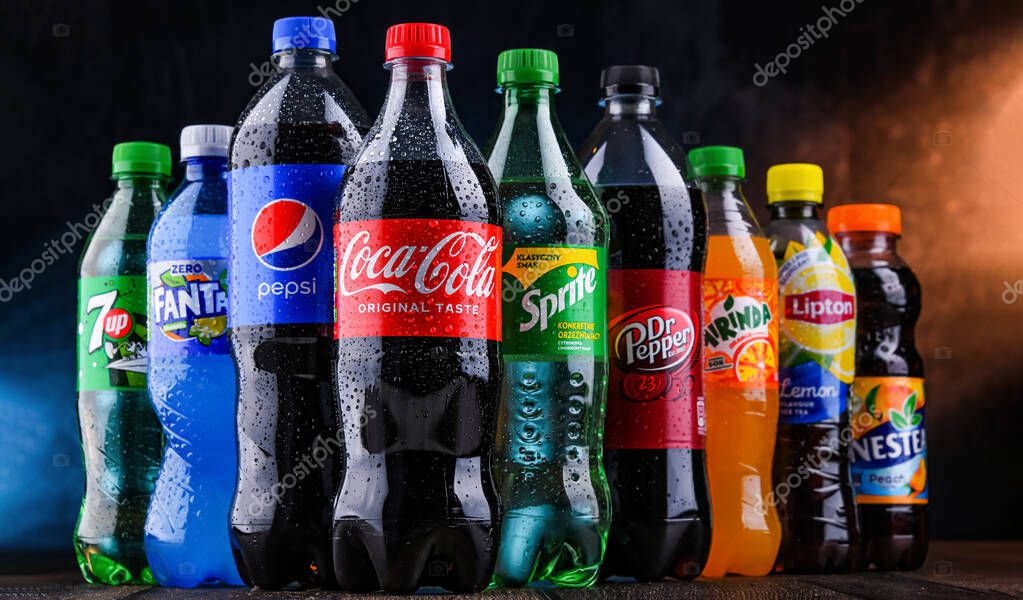 POZNAN, POLAND - OCT 28, 2021: Bottles of global soft drink brands including products of Coca Cola Company and Pepsico