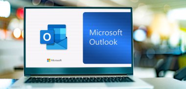 POZNAN, POL - DEC 12, 2021: Laptop computer displaying logo of Microsoft Outlook program, part of the Office family software and services developed by Microsoft
