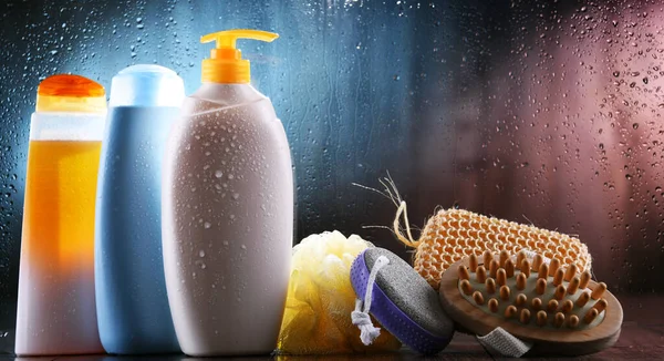 Different containers of body care products in the bathroom.