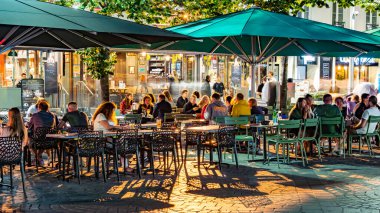 REIMS, FRANCE - AUG 6, 2022: Restaurants in the old town of Reims, France in the night