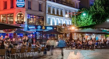 REIMS, FRANCE - AUG 6, 2022: Restaurants in the old town of Reims, France in the night