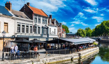 REIMS, FRANCE - AUG 6, 2022: Restaurants at the Somme river in the old town of Amiens, France
