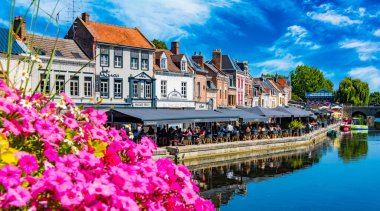 REIMS, FRANCE - AUG 6, 2022: Restaurants at the Somme river in the old town of Amiens, France