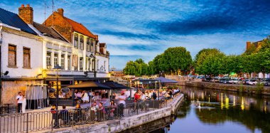 AMIENS, FRANCE - AUG 7, 2022: Restaurants in the old town of Amiens, France after sunset