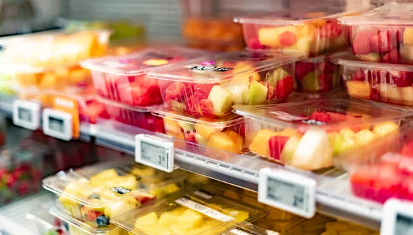 Packages with fresh fruits displayed in a commercial refrigerator