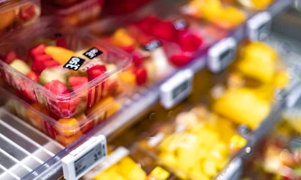 Packages with fresh fruits displayed in a commercial refrigerator